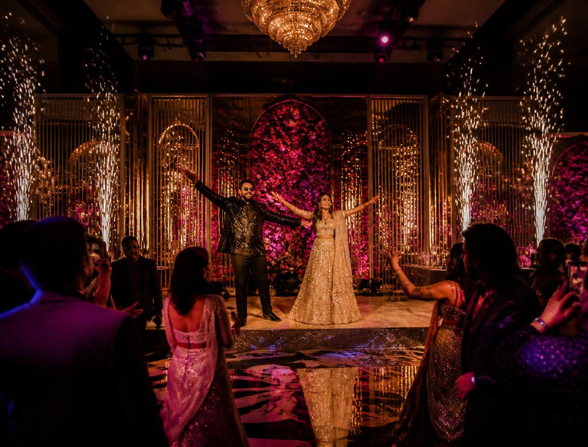 Sangeet night stage with sparklers and gold decor